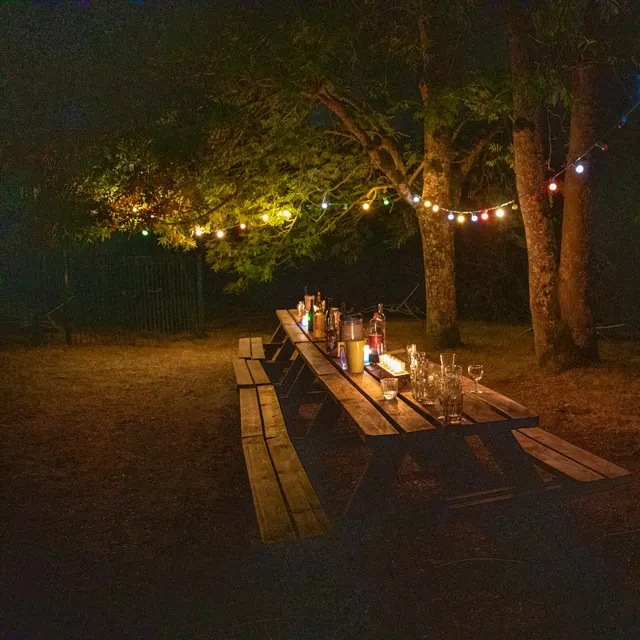 Long table under string lights at night