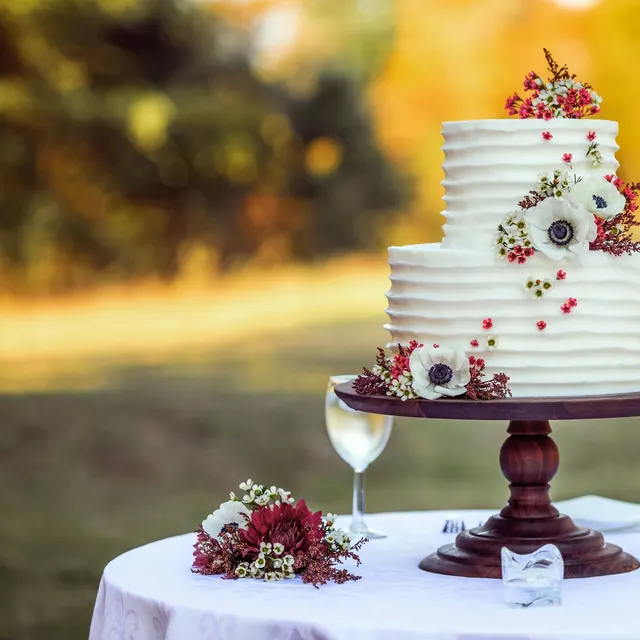 Wedding cake with flowers on a wooden stand
