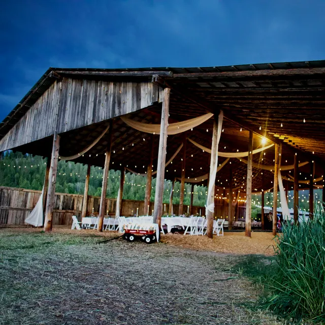 Barn with glowing string lights at dusk